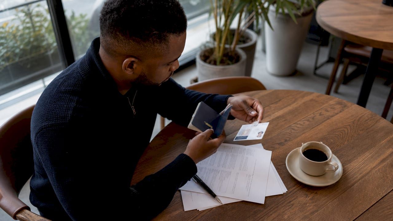 Hands verifying customer identity documents