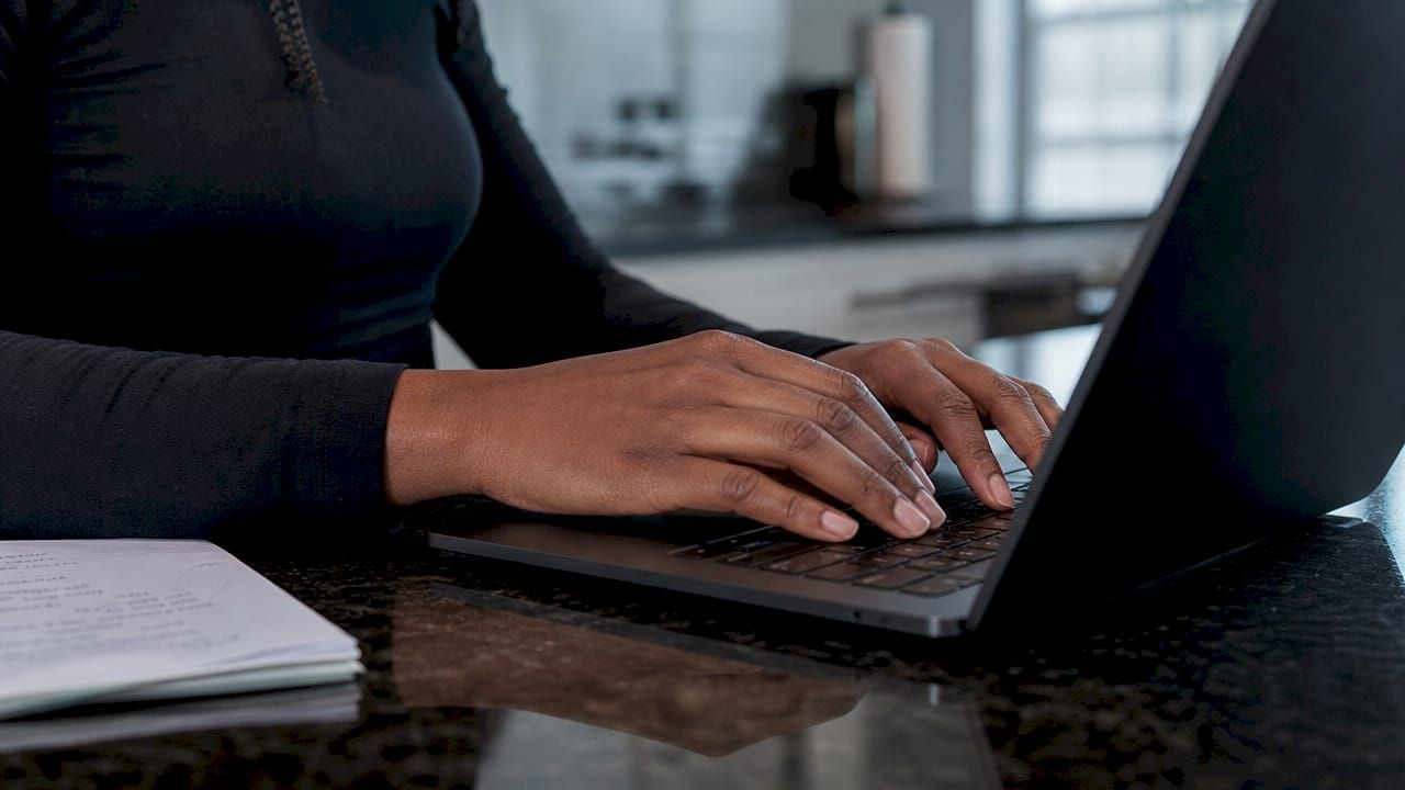 Hands coding authentication software module on laptop