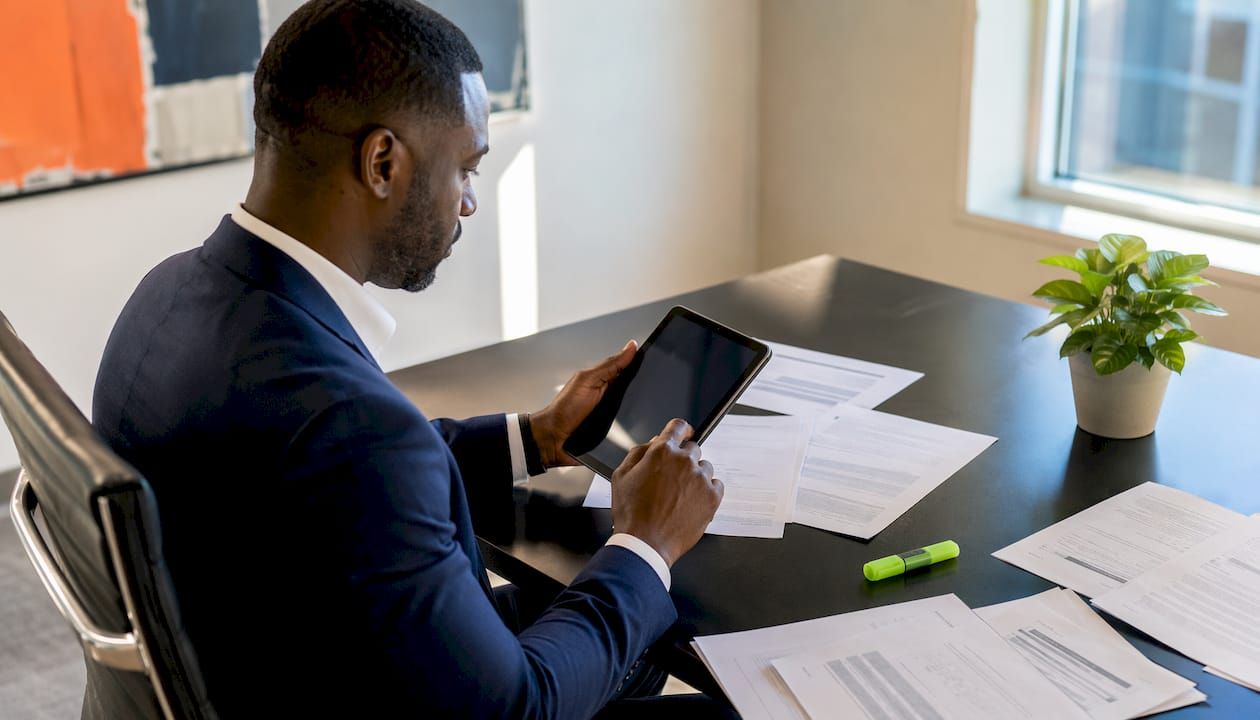 Man reviewing SaaS operational controls on tablet