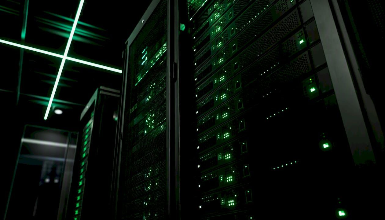 Glowing server racks in a dark tech room